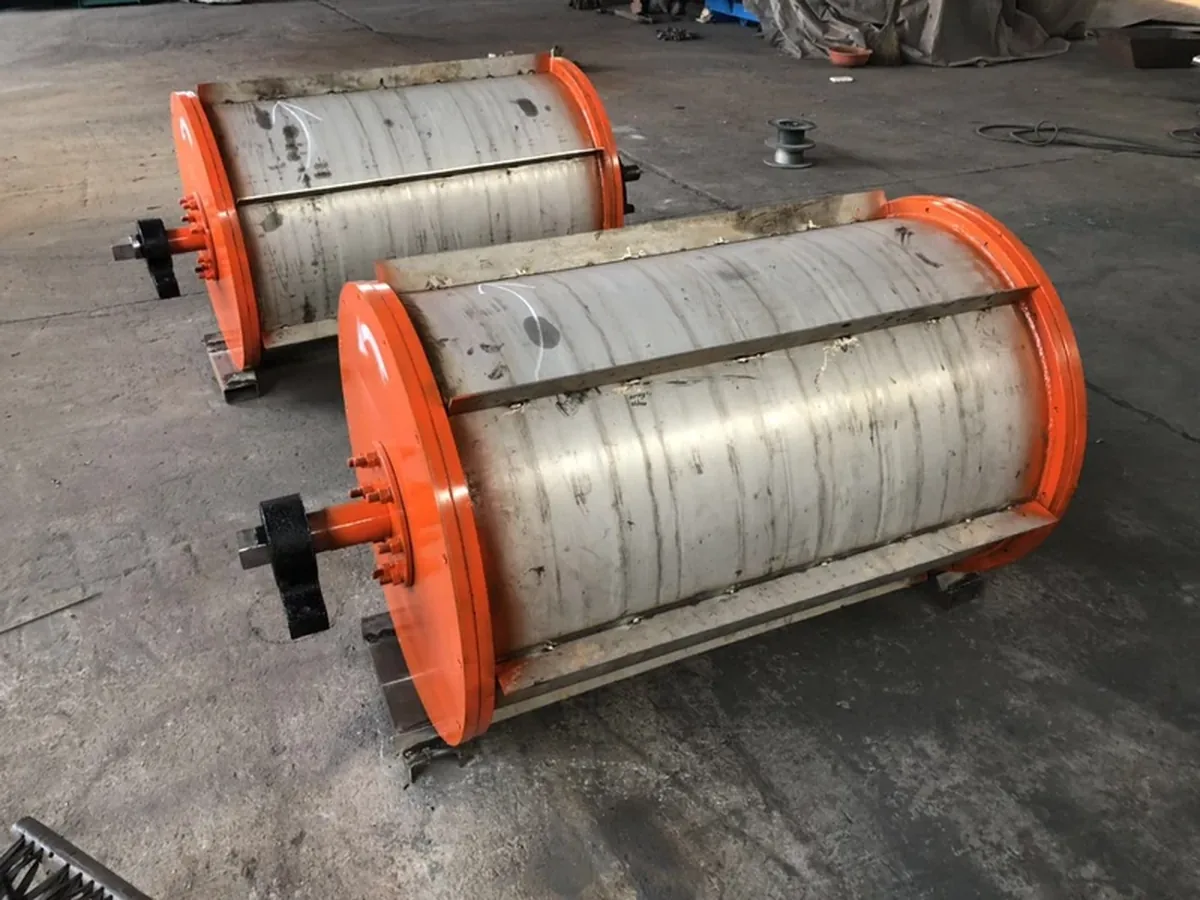 Real Coverlan magnetic drum separator units with cylindrical drum shells and orange end plates in the workshop.